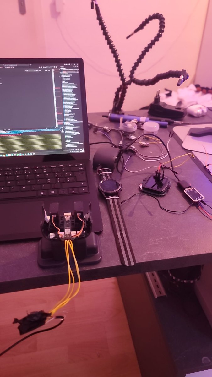 The workbench: laptop showing captured logs, EMO's base opened up with the leg servos wired out.
