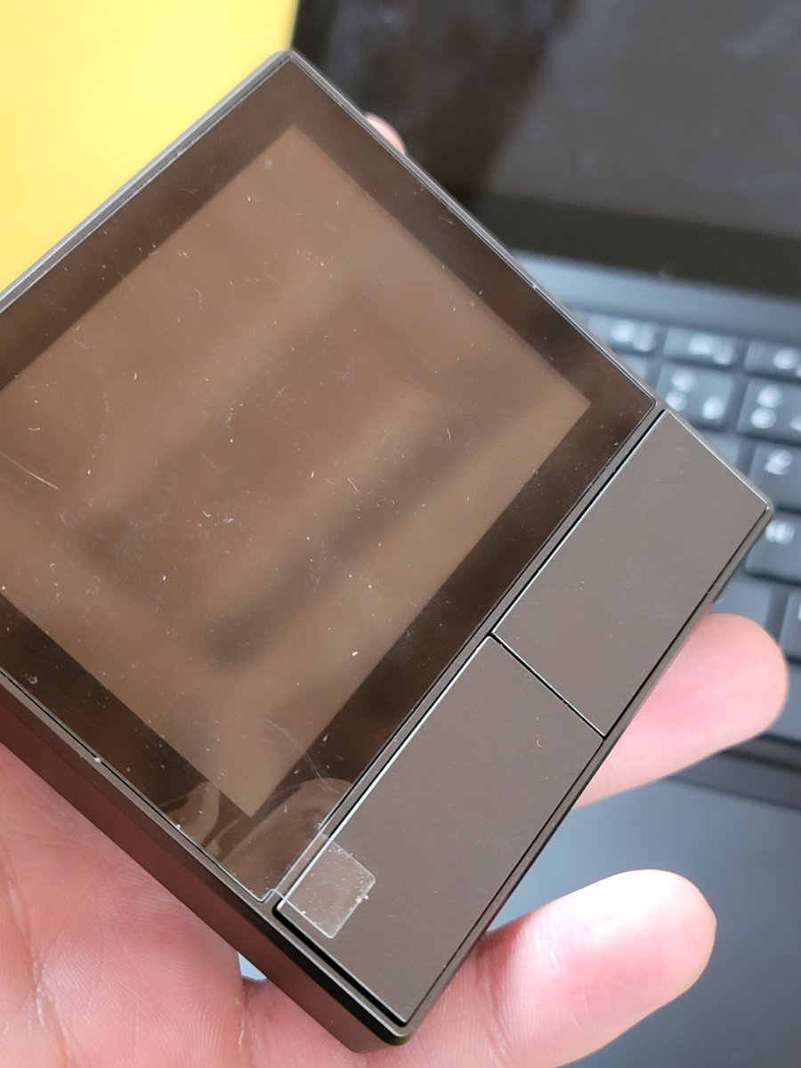 A Sonoff NSPanel held in hand, screen off.