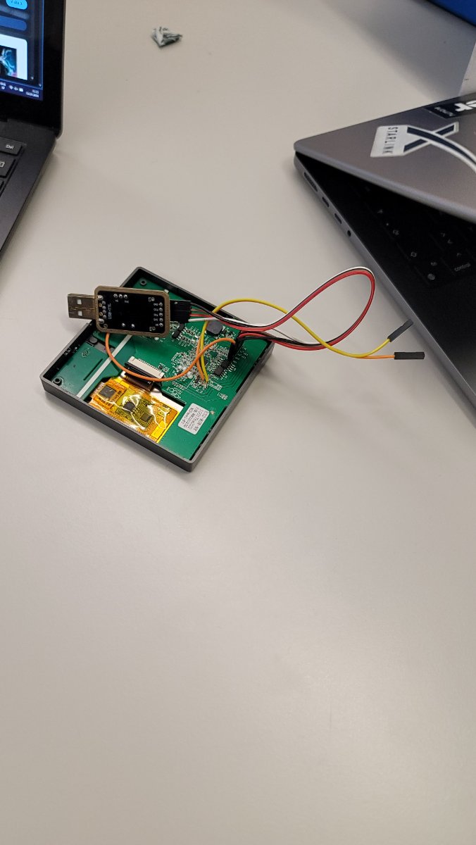 The opened panel wired to a USB-TTL adapter on the bench, mid-flash.