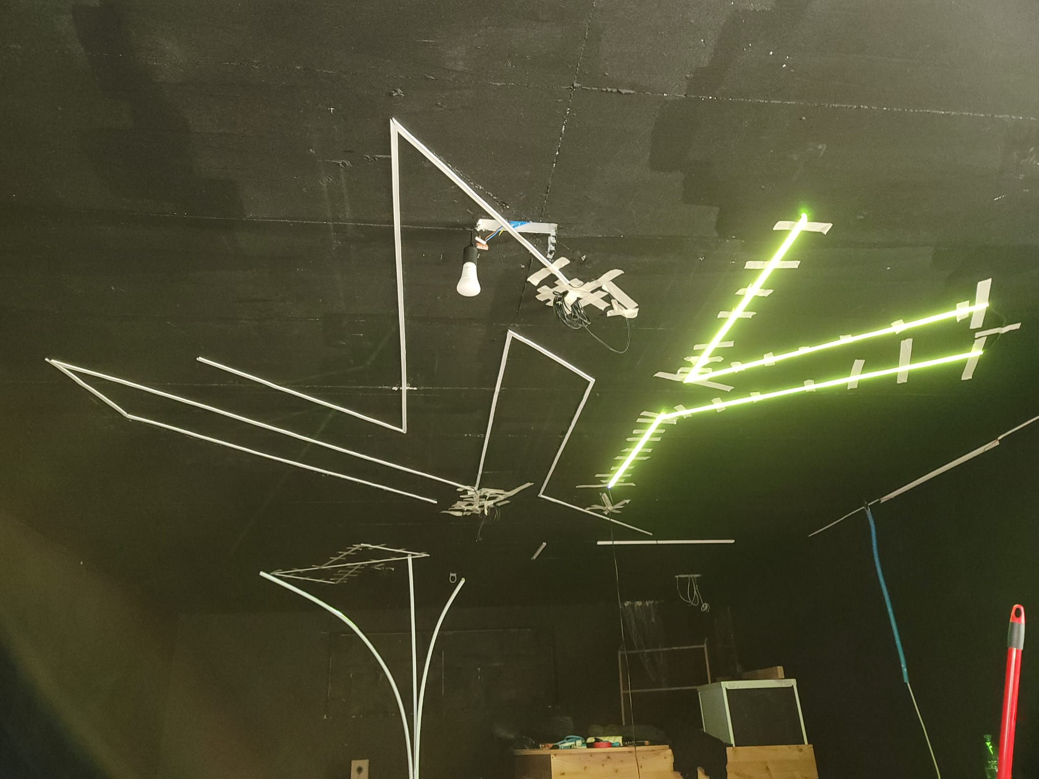 The ceiling strips lit, one branch running green.