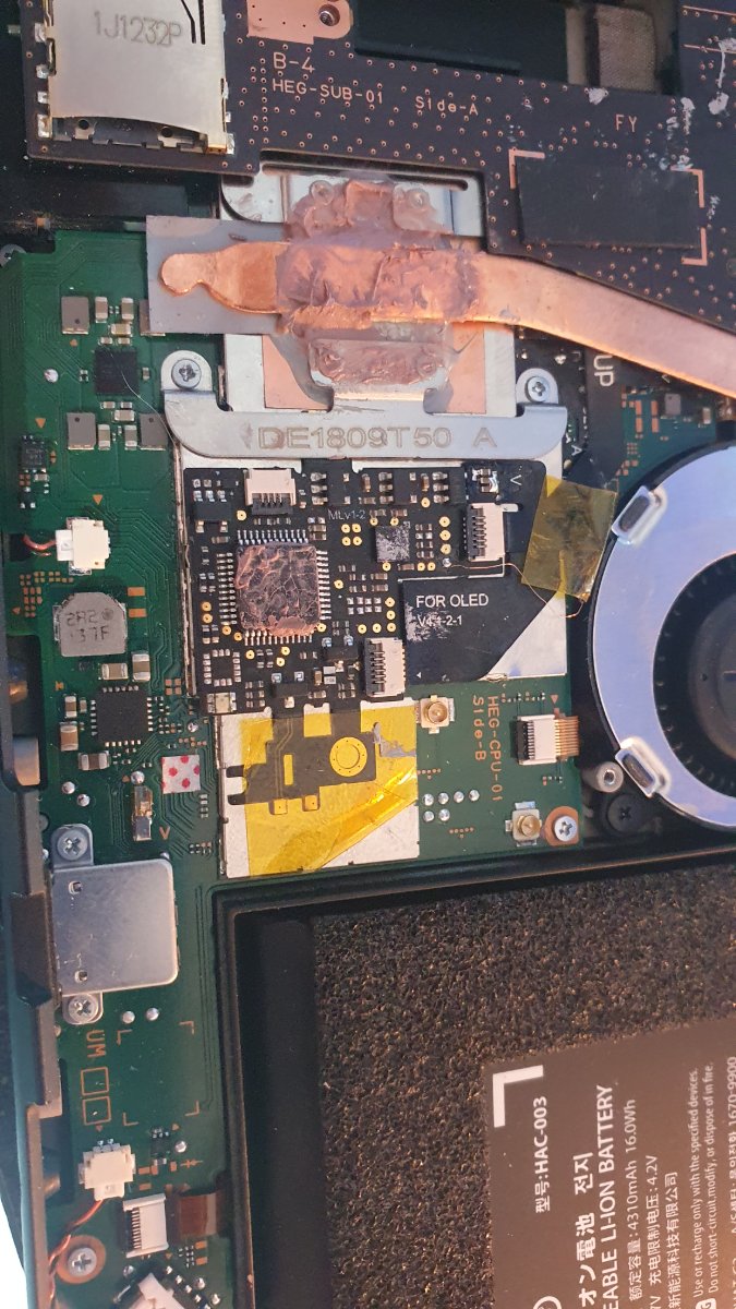 The Switch OLED opened up, with the modchip fitted to the CPU board.